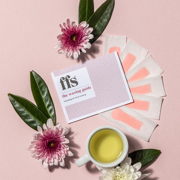 6 FFS facial wax strips laid out surrounded by flowers