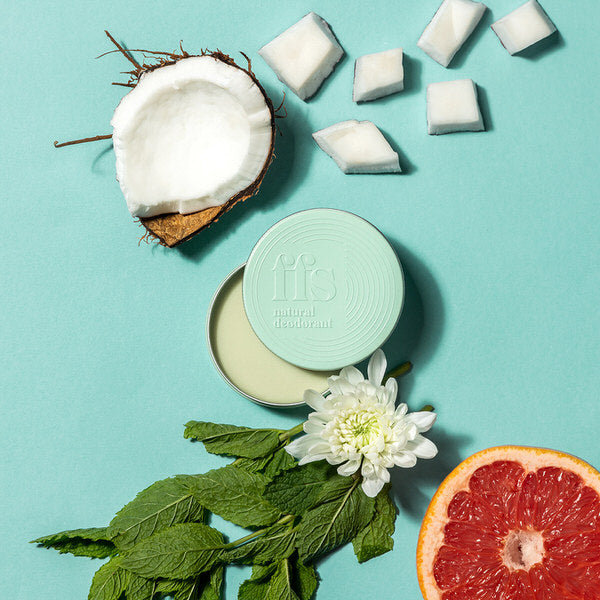 FFS Natural Deodorant surrounded by coconut, peppermint leaves and grapefruit
