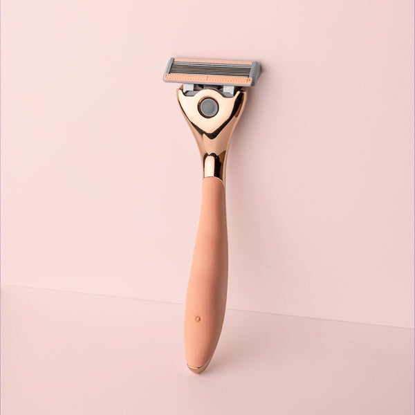 FFS rose gold metal handle with peach rubber grip and a 6 blade razor head attached