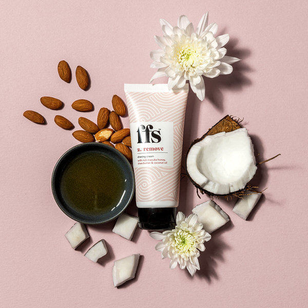 FFS Shave scrub surrounded by a pot of manuka honey, almonds, walnuts, coconut and flowers